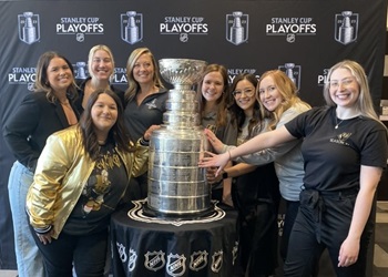 Stephanie Rogers next to Stanley Cup