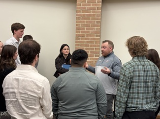 Students talking to sport management professional