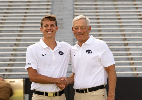 Carter Klein shaking hands with Kirk Ferentz