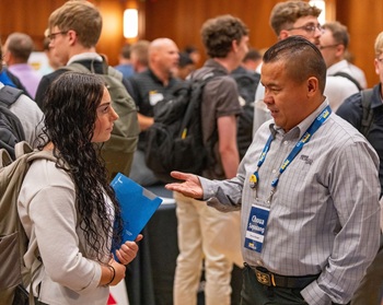 Musco recruiter talking to student.