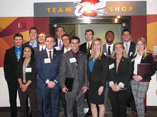 Students posing in front of Cavaliers team store.