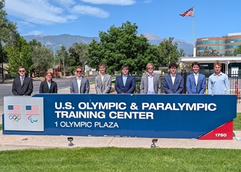 Students standing behind US Olympic Facility sign