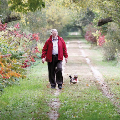Professor Ben Hunnicutt walking with his dog