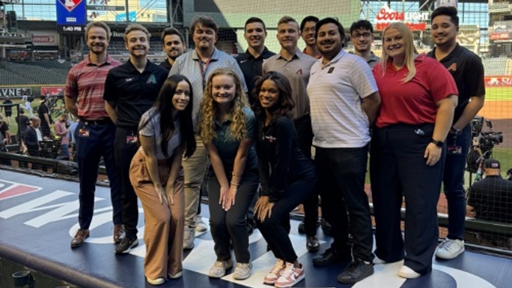 UISRM graduates, Marc Cortez (third from right) and Hunter Arbogast (back row in center), pose in Chase Field at the World Series with colleagues. They both graduated in May 2023 with their Bachelor of Science degrees in Sport and Recreation Management and now work as New Business Consultants for the Arizona Diamondbacks.