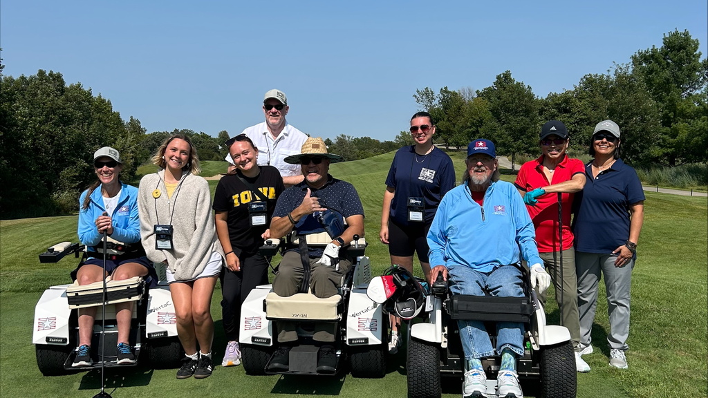 Veterans and TR students using adaptive golf carts 